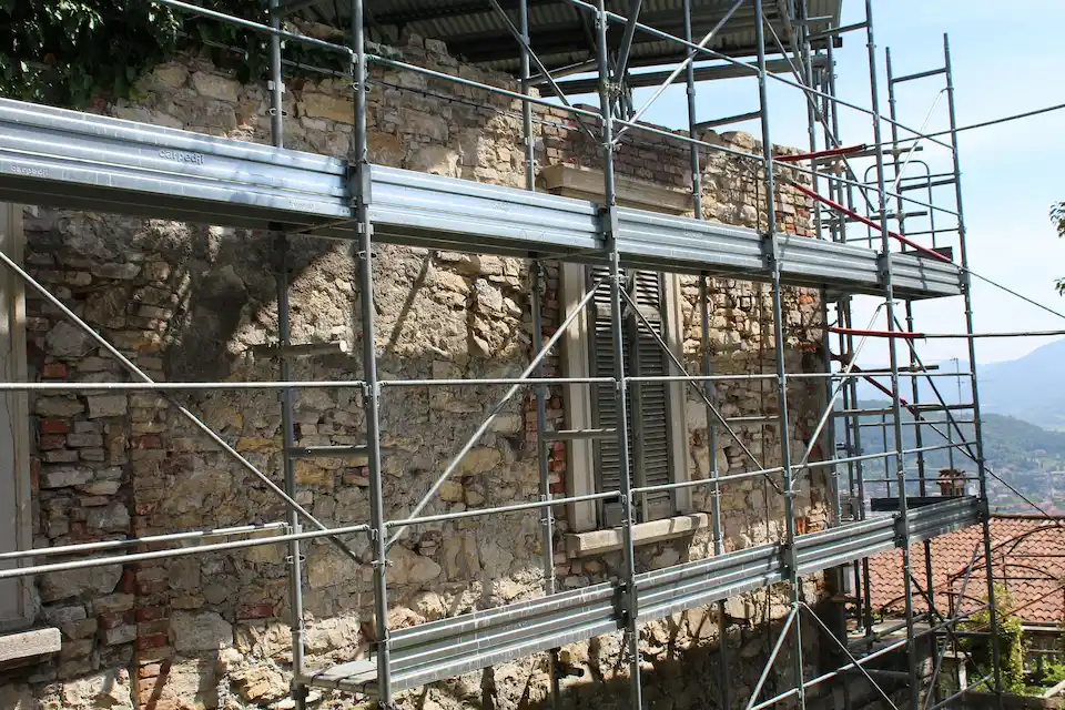 Multi-level scaffolding setup surrounding a stone building restoration project in Stockton