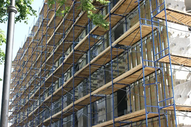 Large blue multi-level scaffolding system installed on a commercial building in Stockton