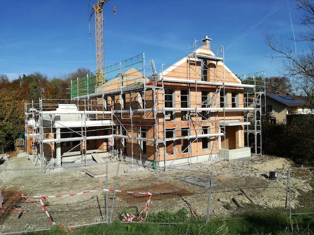 Residential home construction project with surrounding scaffolding setup in Stockton