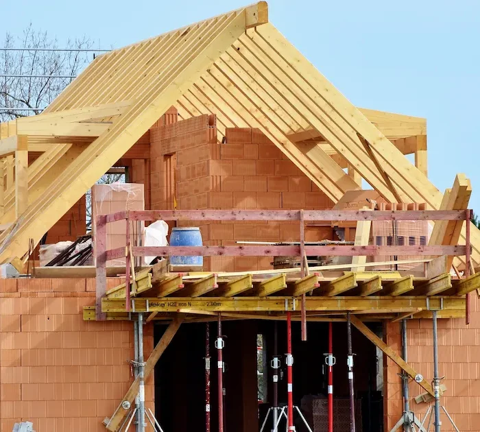 Temporary scaffolding platform supporting roof framing and home construction in Stockton